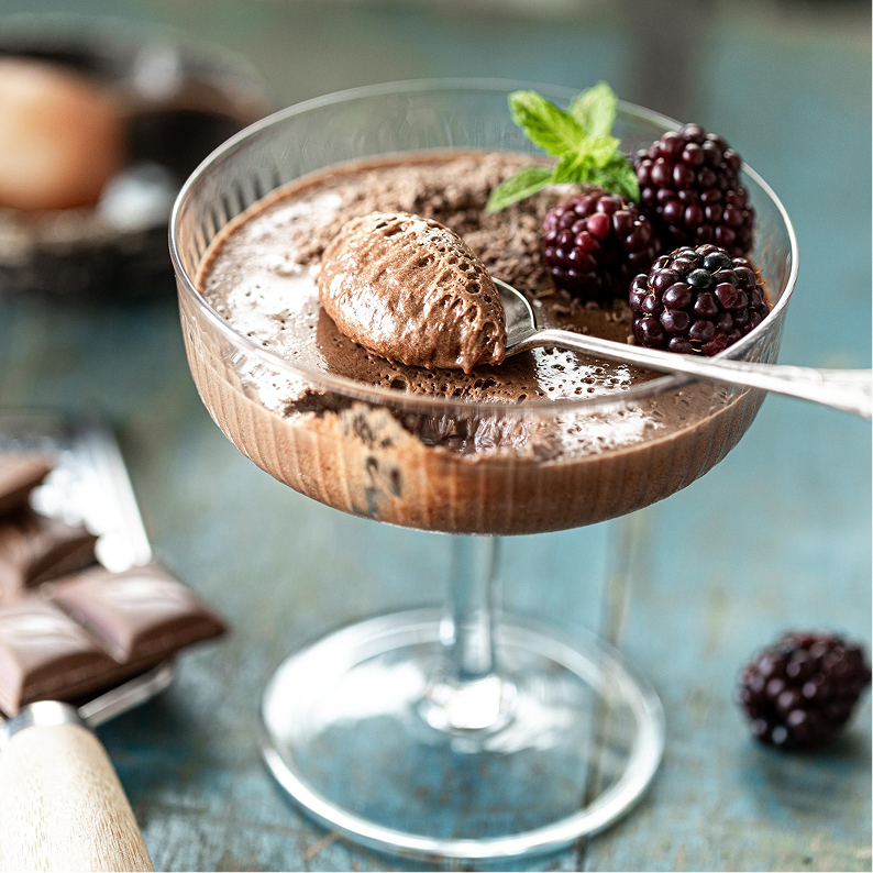 Chocolate mousse in a glass glass with fresh blackberries and mint